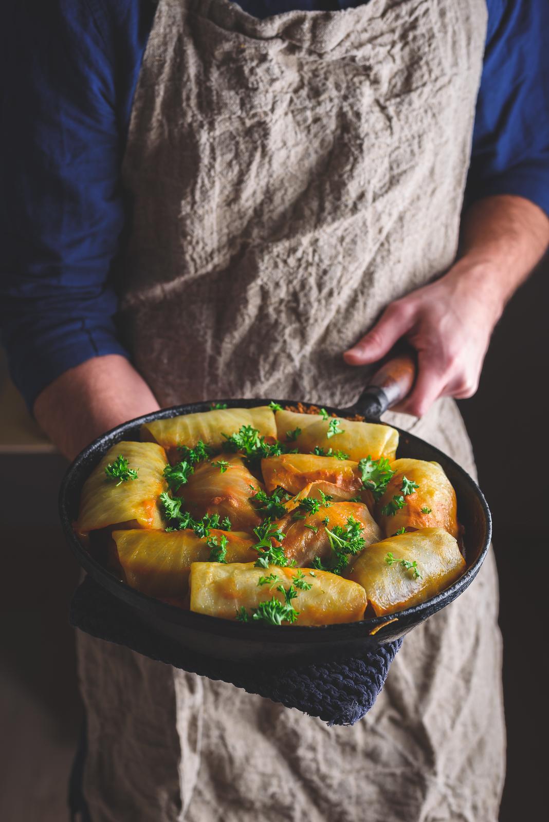 Chef Holding Pan with Cooked Cabbage Rolls