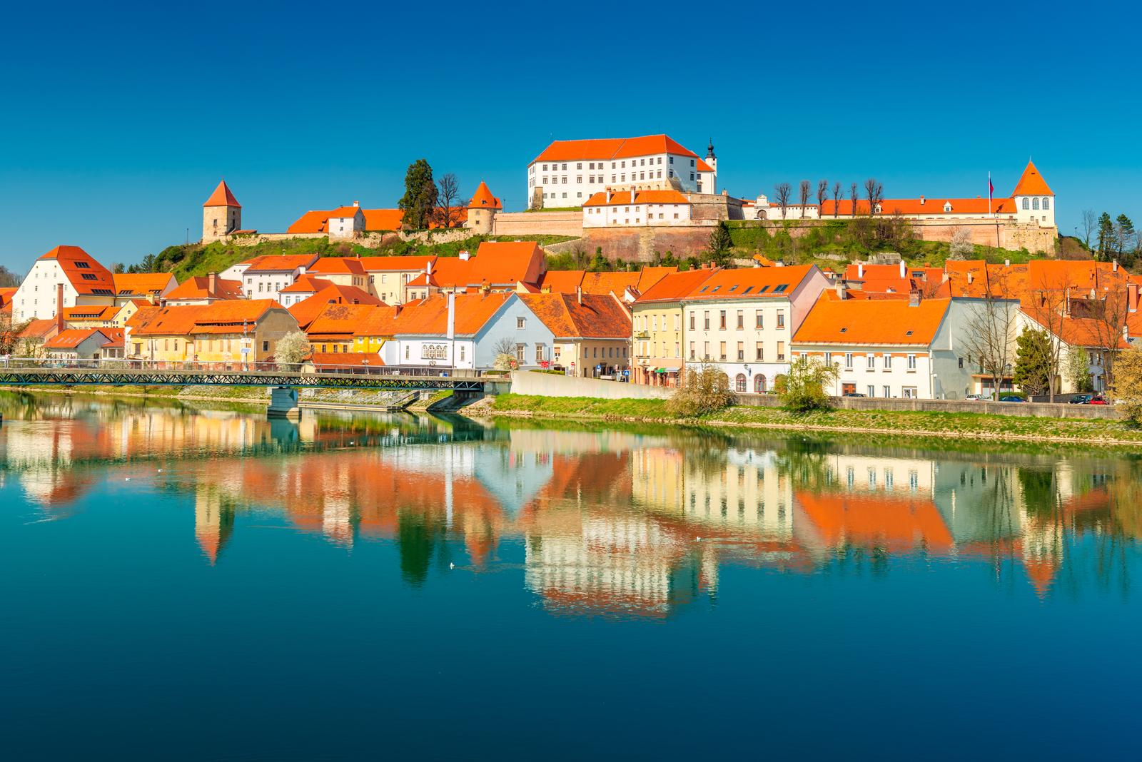 Picturesque European town reflected in the water. Ptuj, Slovenia